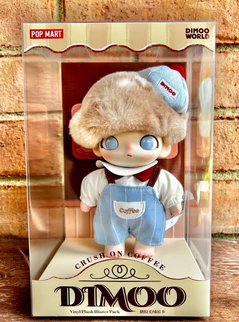 Dimoo toy figure in packaging with 'Pop Mart' branding on a wooden surface.